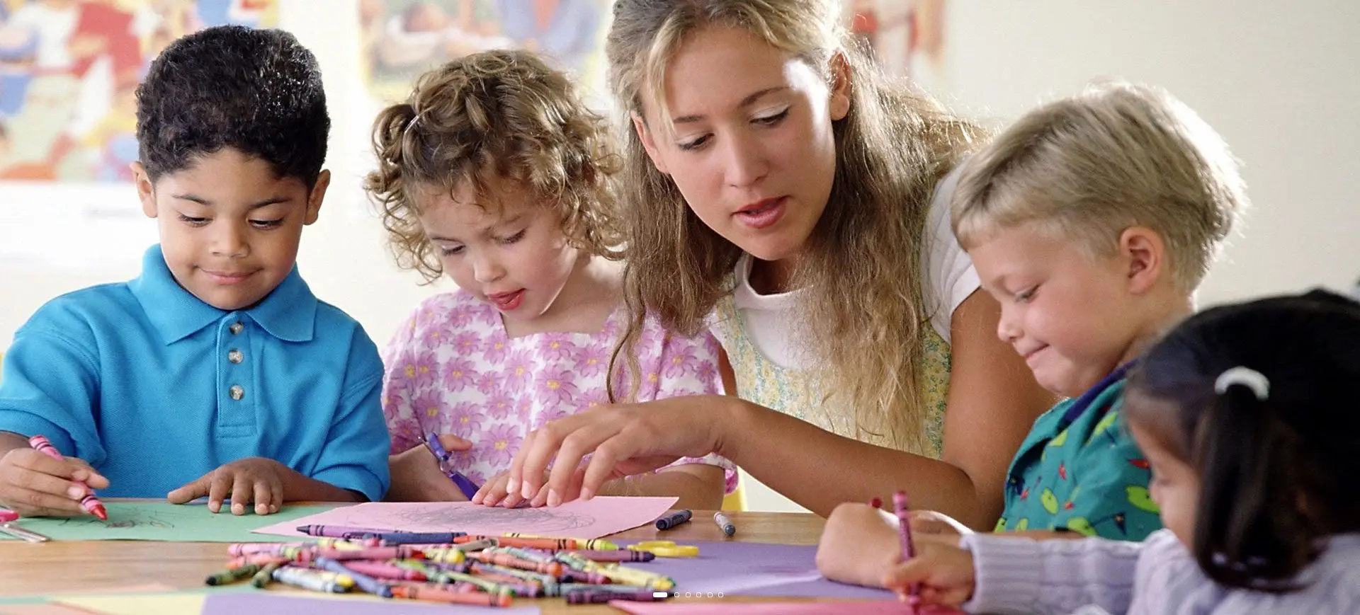 A woman and two children are working on crafts.